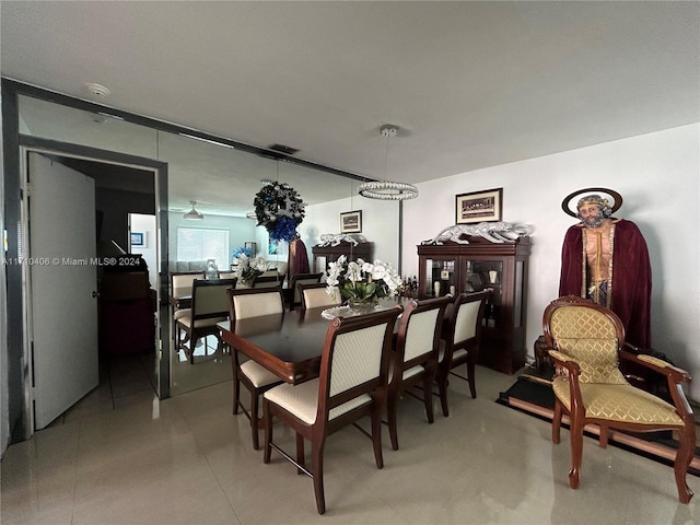 dining room featuring ceiling fan with notable chandelier