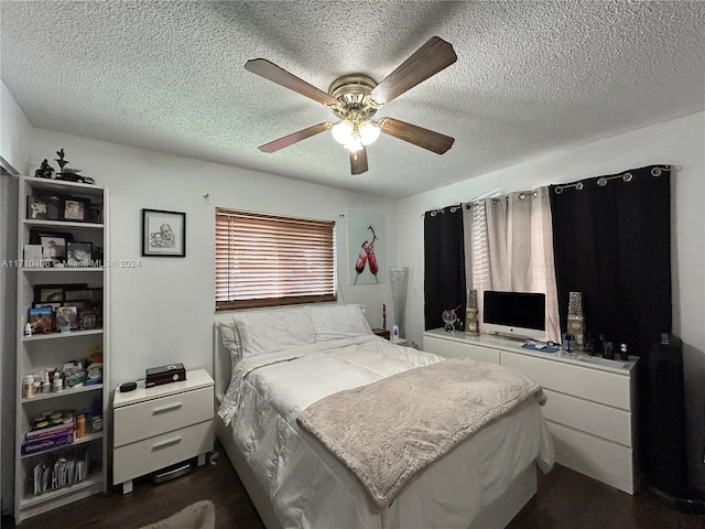 bedroom featuring a textured ceiling, ceiling fan, and dark wood-type flooring