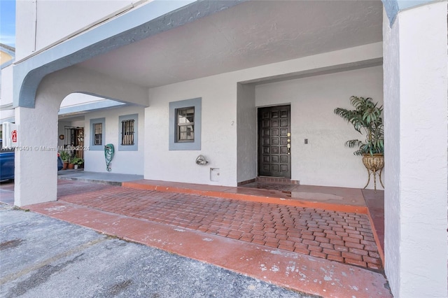 view of exterior entry with covered porch