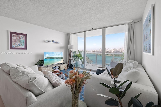 living room featuring a wall of windows and a textured ceiling