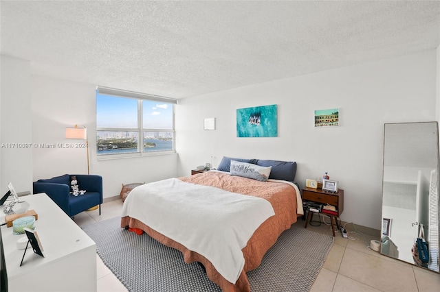 tiled bedroom with a textured ceiling