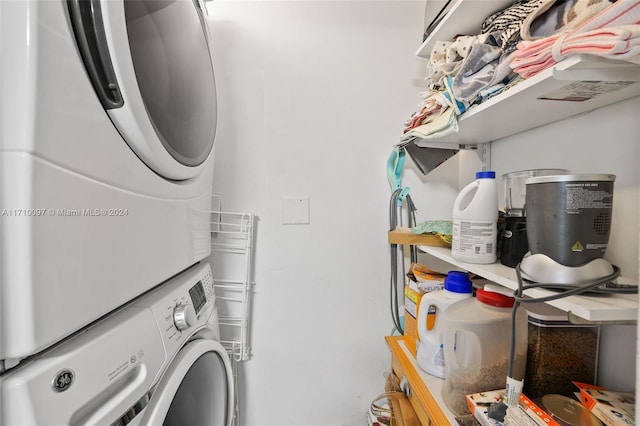 clothes washing area with stacked washer / dryer