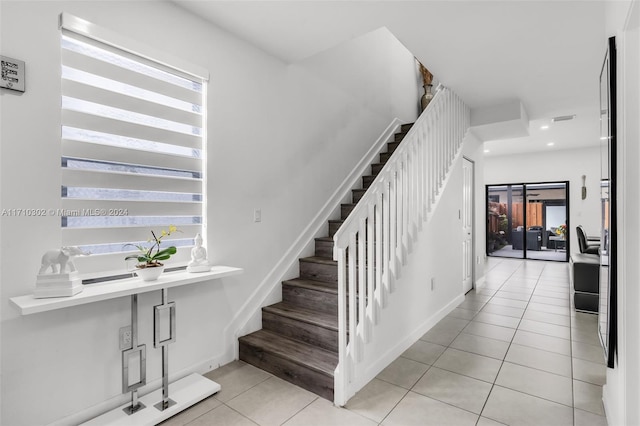 stairway featuring tile patterned flooring