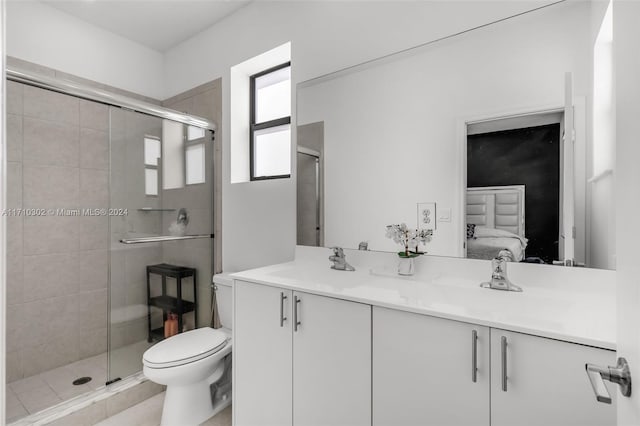 bathroom featuring vanity, toilet, and an enclosed shower