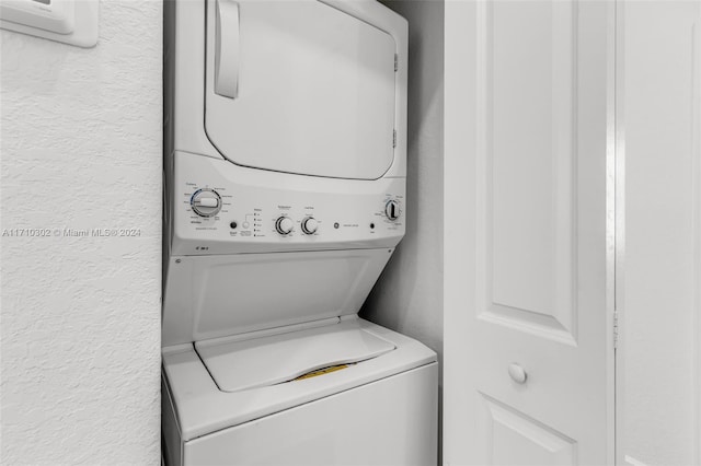 laundry area with stacked washing maching and dryer