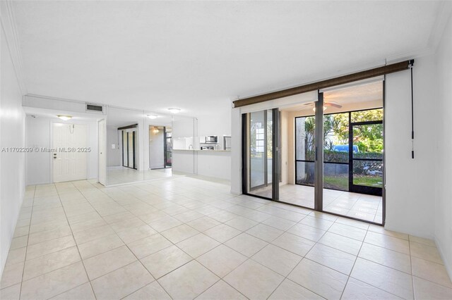 kitchen with light tile patterned floors, stainless steel appliances, light stone counters, and sink