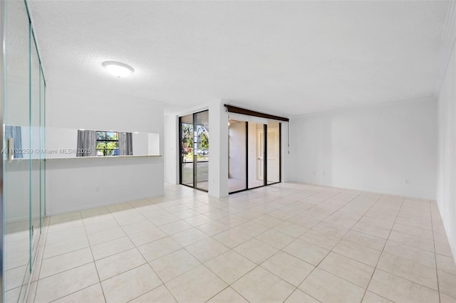 empty room with light tile patterned floors and a textured ceiling