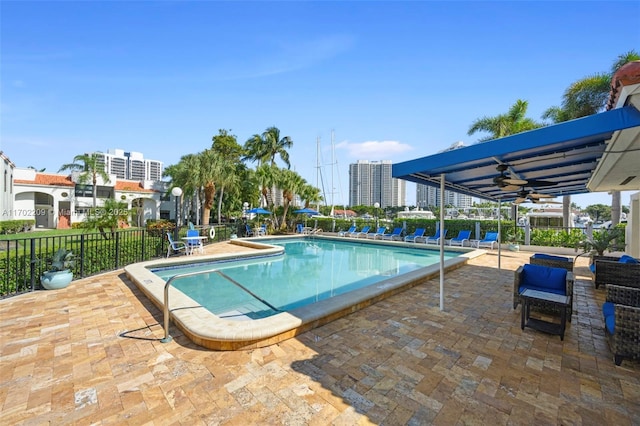 view of pool featuring ceiling fan and a patio