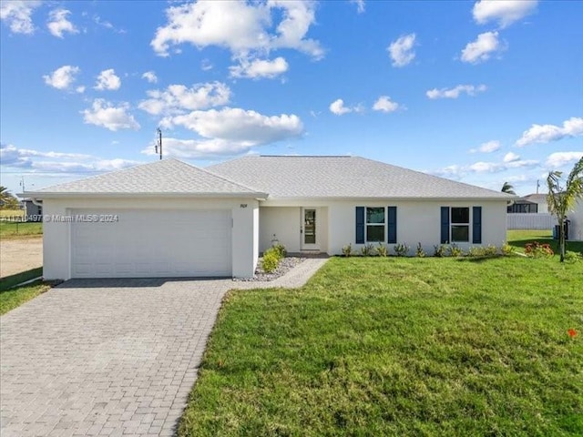 single story home featuring a front yard and a garage