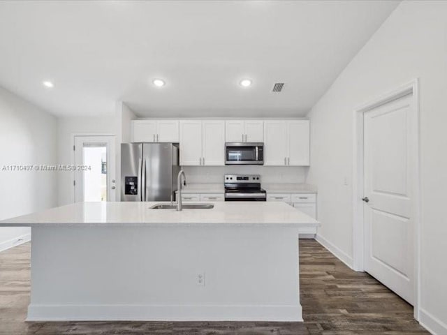 kitchen featuring white cabinets, stainless steel appliances, a center island with sink, and sink