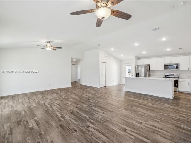 unfurnished living room featuring ceiling fan, lofted ceiling, and dark wood-type flooring