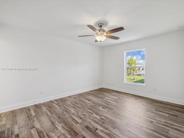 spare room with ceiling fan and hardwood / wood-style flooring