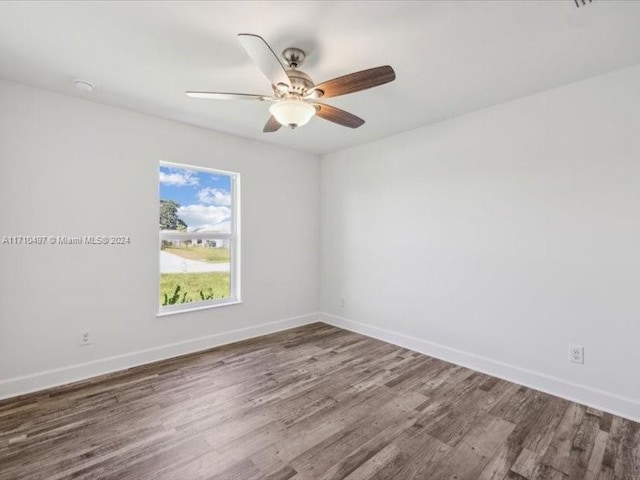 spare room with wood-type flooring and ceiling fan