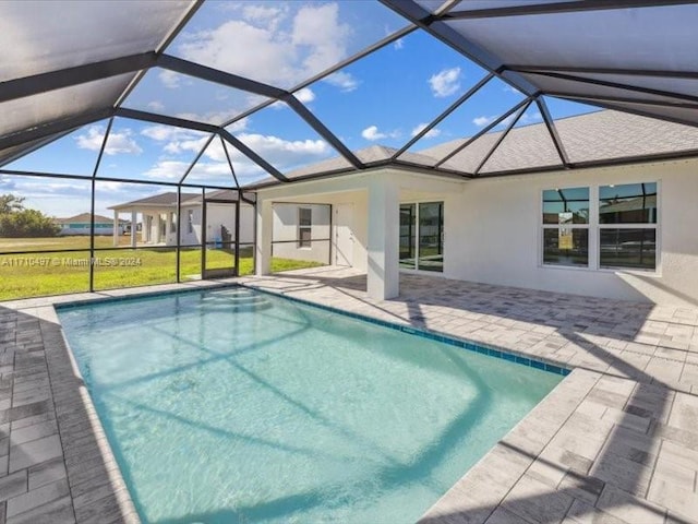 view of swimming pool with a lanai and a patio