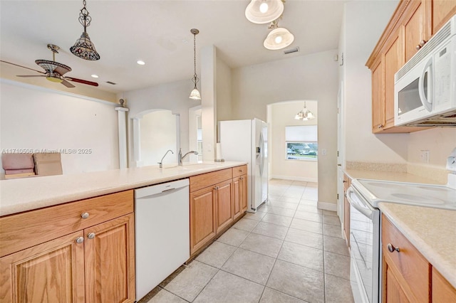 kitchen featuring white appliances, hanging light fixtures, light tile patterned floors, sink, and ceiling fan