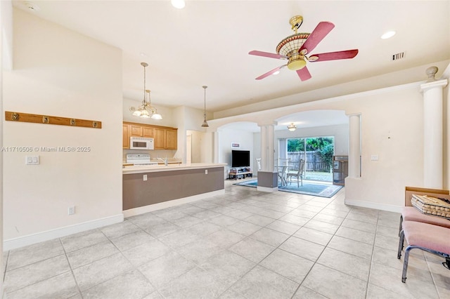 unfurnished living room featuring light tile patterned floors, ceiling fan, and ornate columns