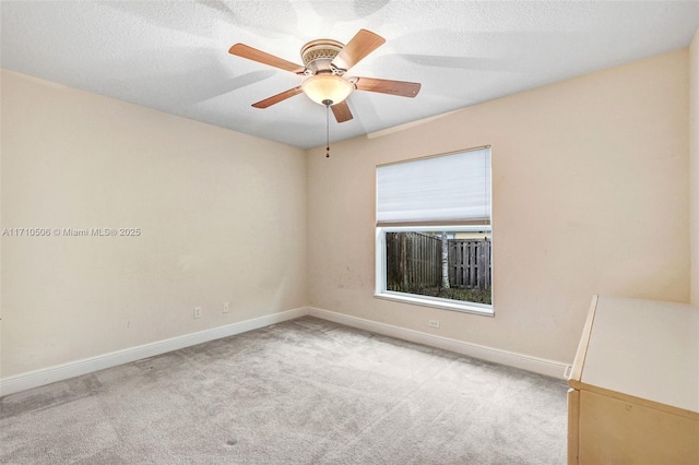 unfurnished room featuring ceiling fan and light colored carpet