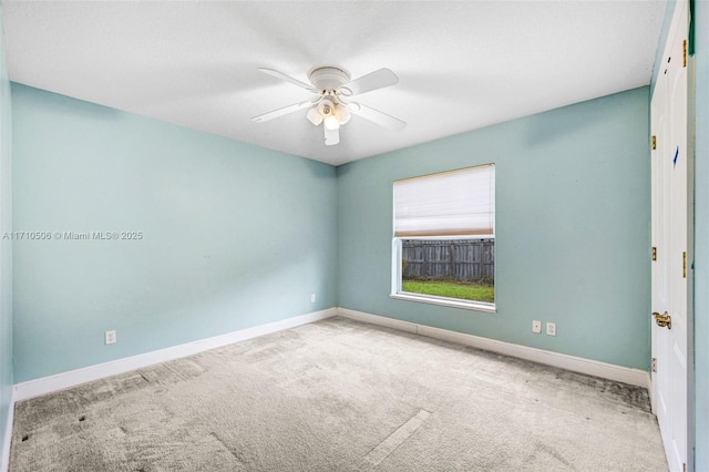 unfurnished room with light colored carpet and ceiling fan