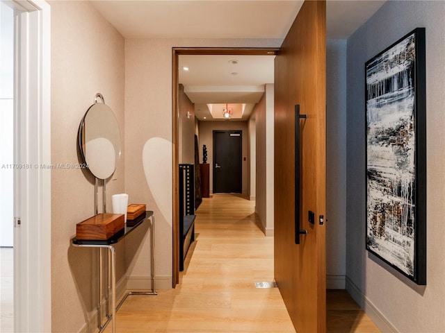 corridor with light hardwood / wood-style flooring