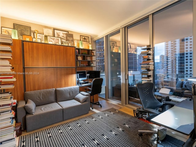 office featuring light hardwood / wood-style flooring and a wall of windows