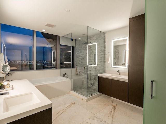 bathroom featuring vanity and shower with separate bathtub