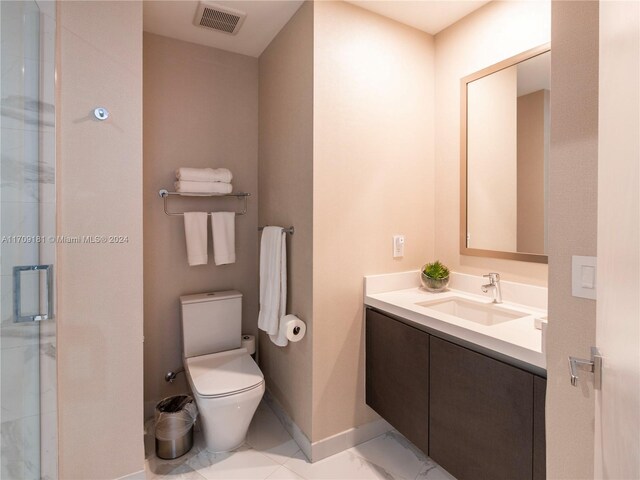 bathroom featuring vanity, toilet, and walk in shower