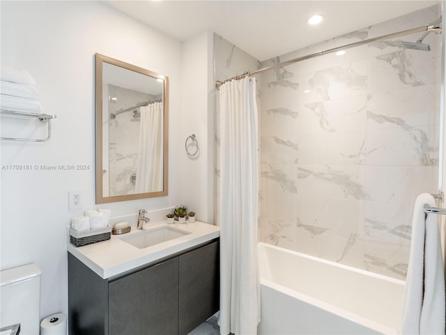 full bathroom featuring shower / bath combo, vanity, and toilet