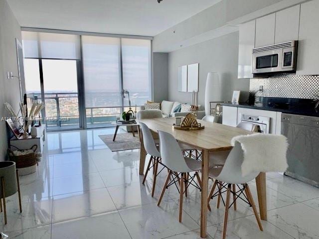 dining area featuring floor to ceiling windows and plenty of natural light