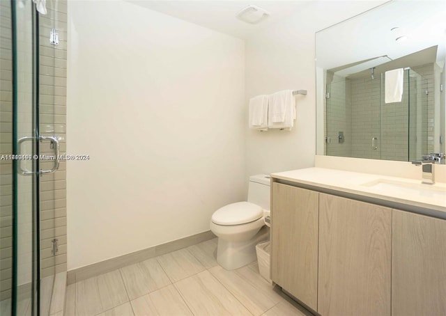 bathroom with vanity, an enclosed shower, and toilet