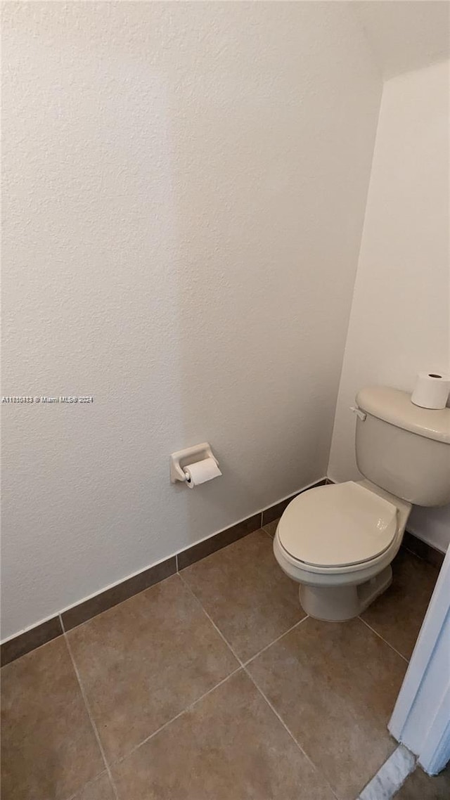 bathroom with tile patterned flooring and toilet