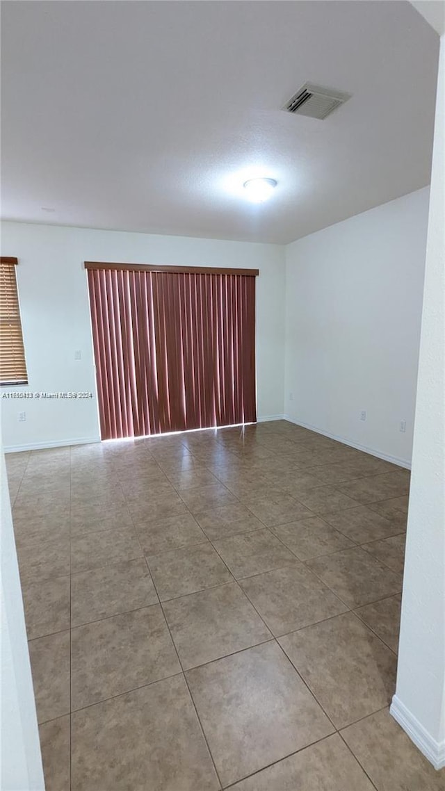 spare room featuring tile patterned flooring