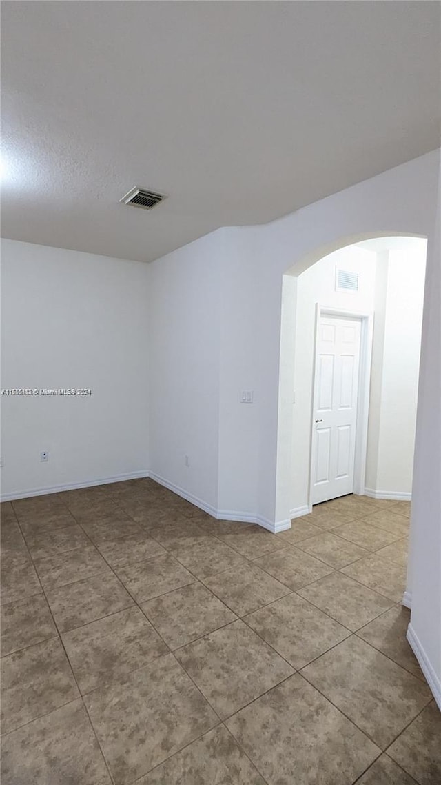 spare room with tile patterned floors