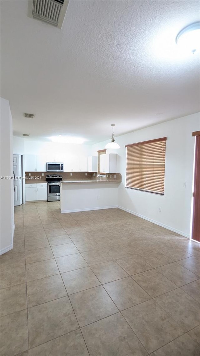 unfurnished living room featuring light tile patterned flooring