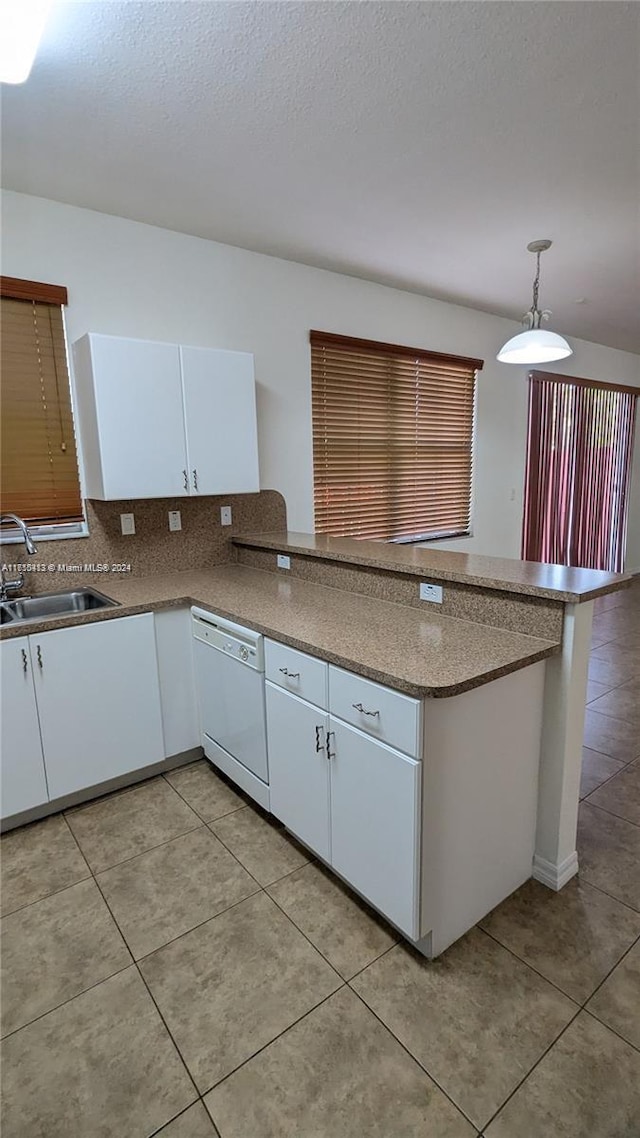 kitchen featuring white cabinetry, dishwasher, pendant lighting, and sink