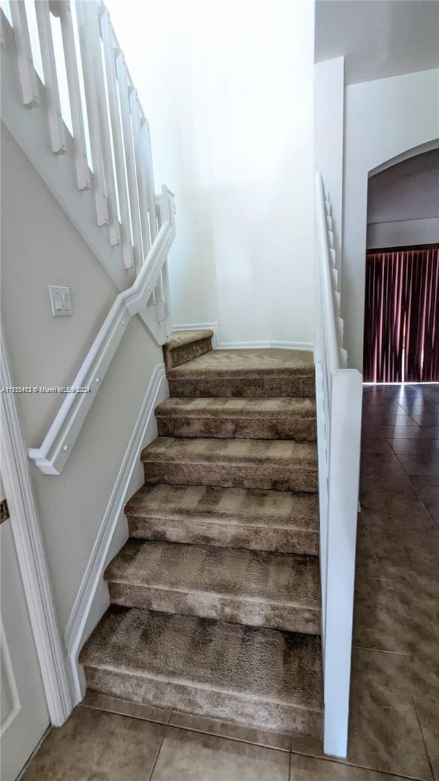 stairway with tile patterned flooring