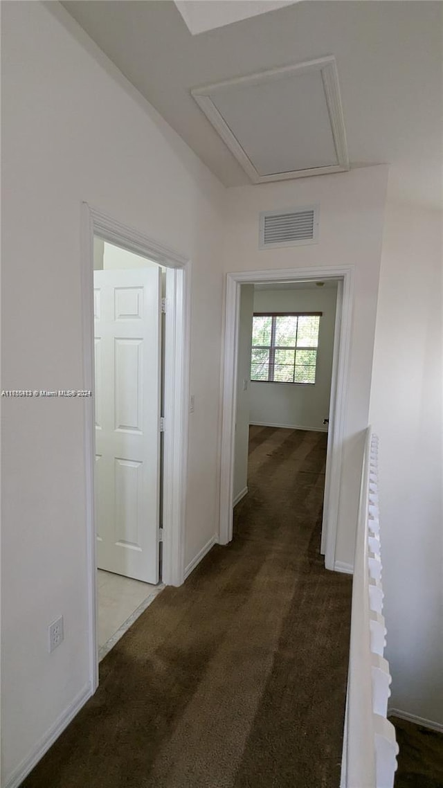 corridor with dark colored carpet