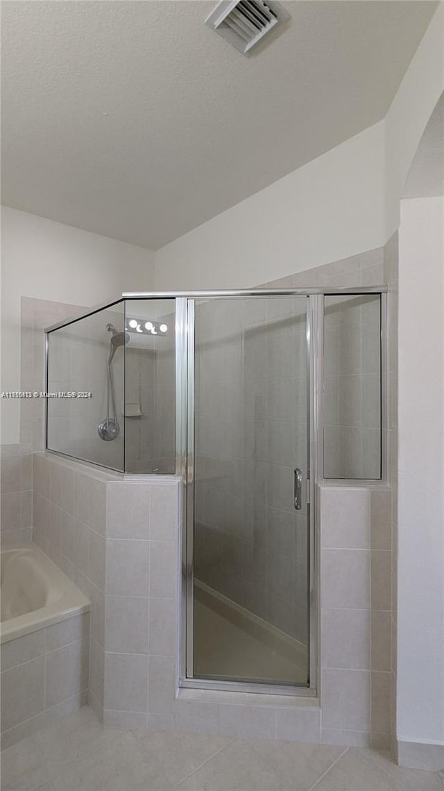 bathroom featuring separate shower and tub and tile patterned floors