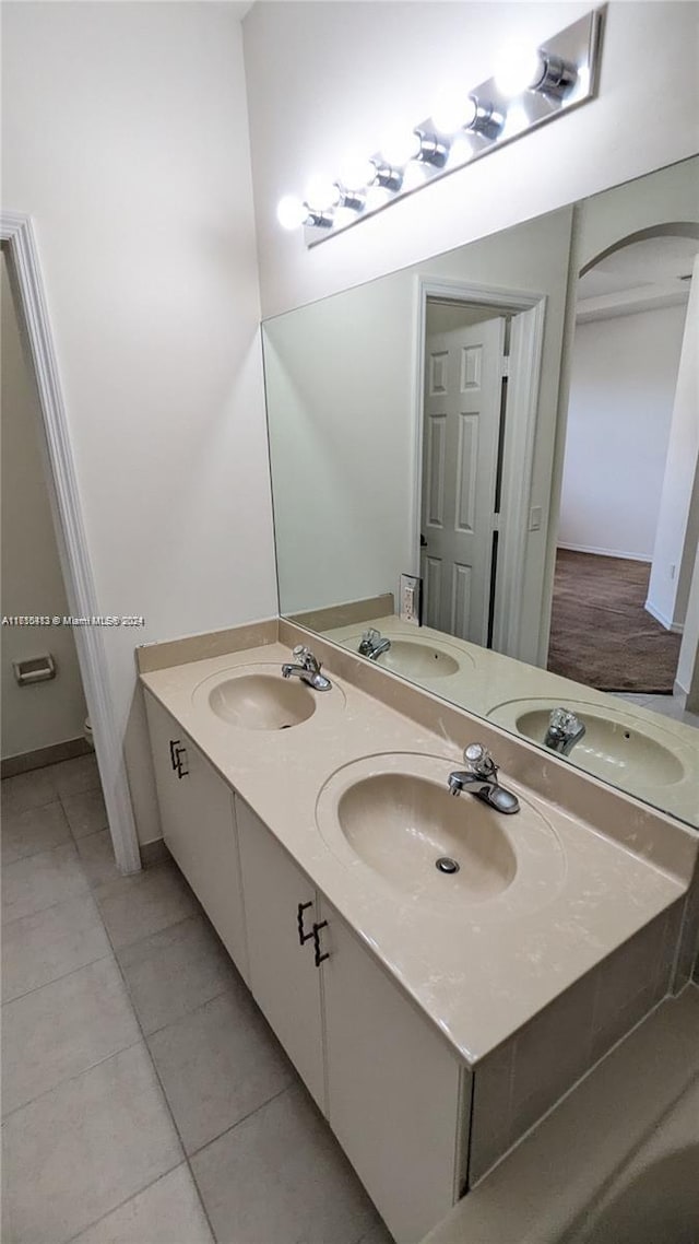 bathroom with tile patterned flooring and vanity