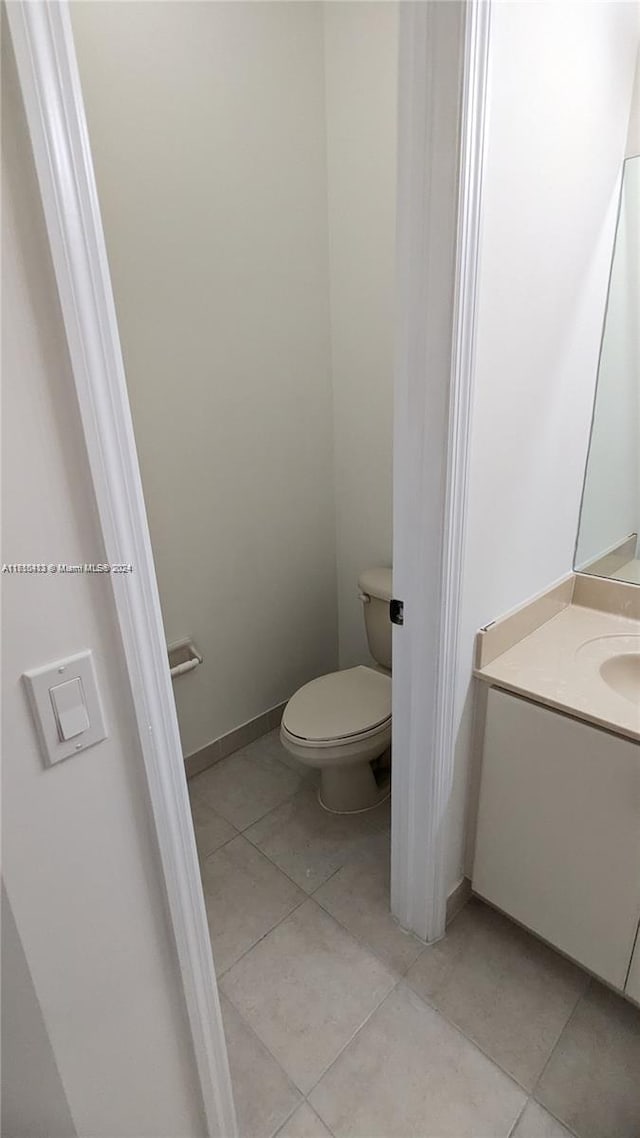 bathroom featuring tile patterned floors, vanity, and toilet