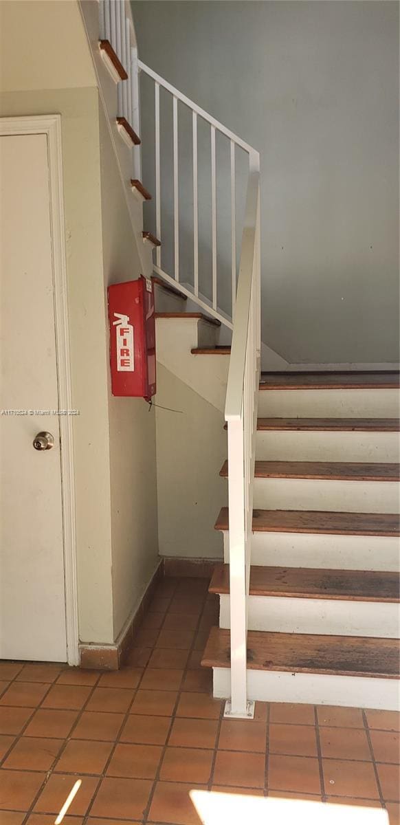 staircase with tile patterned floors