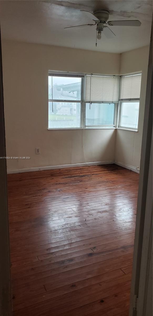 spare room featuring ceiling fan and wood-type flooring