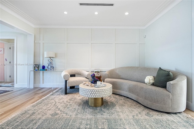 living room featuring crown molding and wood-type flooring