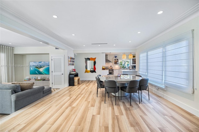 dining area featuring light hardwood / wood-style flooring and ornamental molding