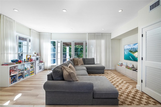 living room with french doors and light hardwood / wood-style floors