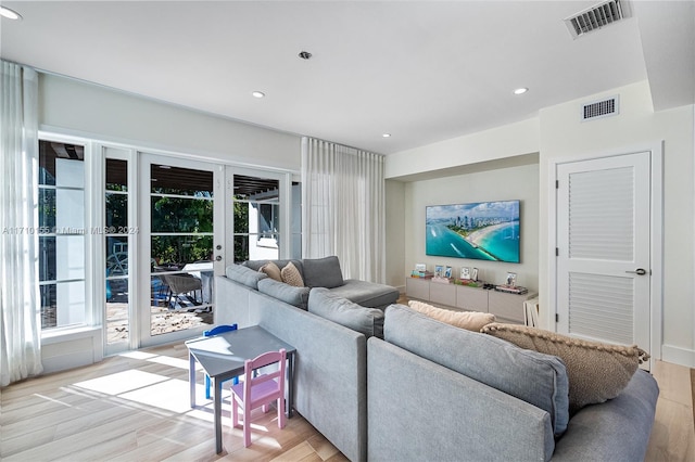 living room with light hardwood / wood-style floors and french doors