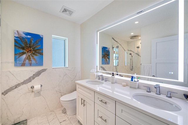 bathroom featuring tile patterned floors, walk in shower, vanity, tile walls, and toilet