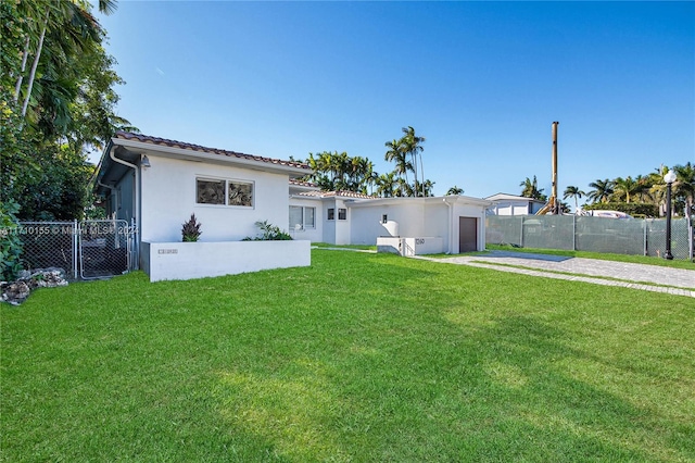 view of front of home featuring a garage and a front lawn