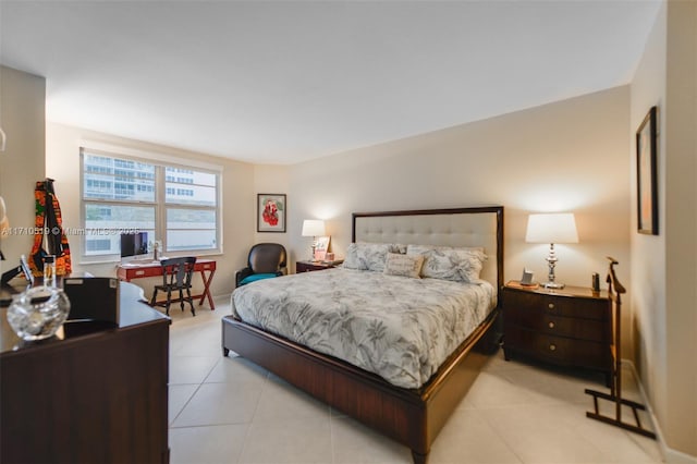 bedroom with light tile patterned flooring and baseboards