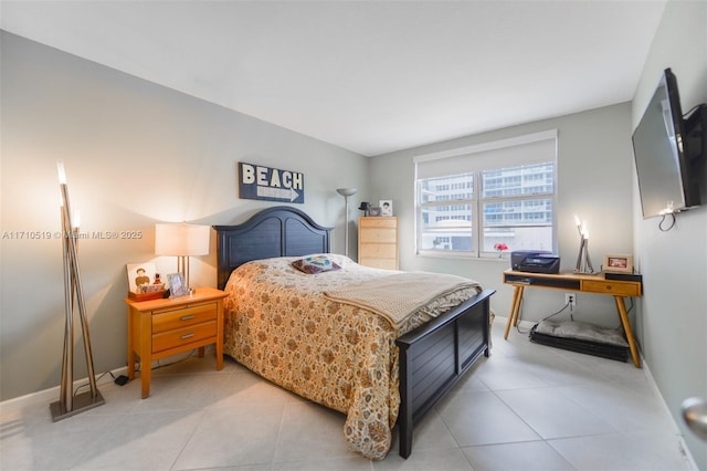 bedroom featuring tile patterned flooring and baseboards