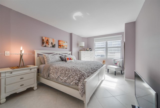 bedroom featuring baseboards and light tile patterned floors